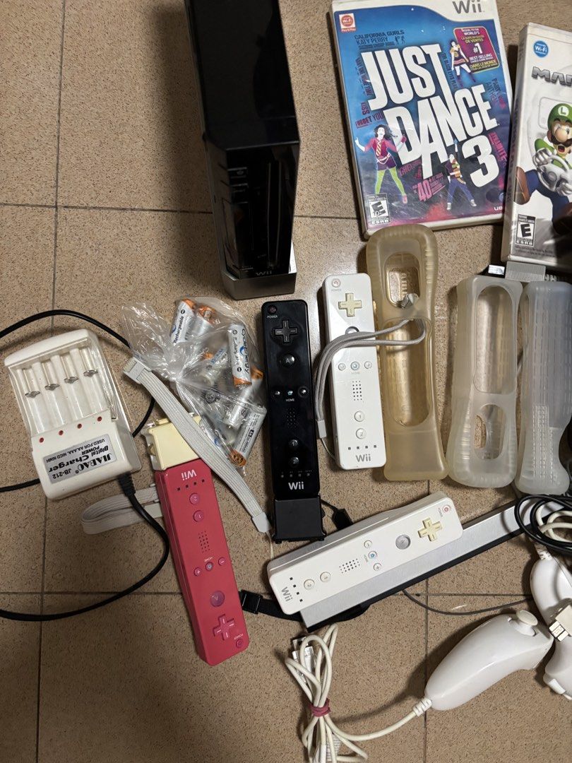 Nintendo Wii Black Console Bundle with Games and Accessories (Category: Nintendo) located in Manila. Submitted by riley523 (Listing ID 1468214365, Image 2). Description: WII FULL SET Inclusions: 1 console with stand Power cord Hdmi cord Motion sensor 2 original remote control (with additional sensor included each) 2 additional controllers 4 nunchucks 3 steering wheels Physical Games included: Mario cart Just dance 3 Wii Sports Wii sports resort F