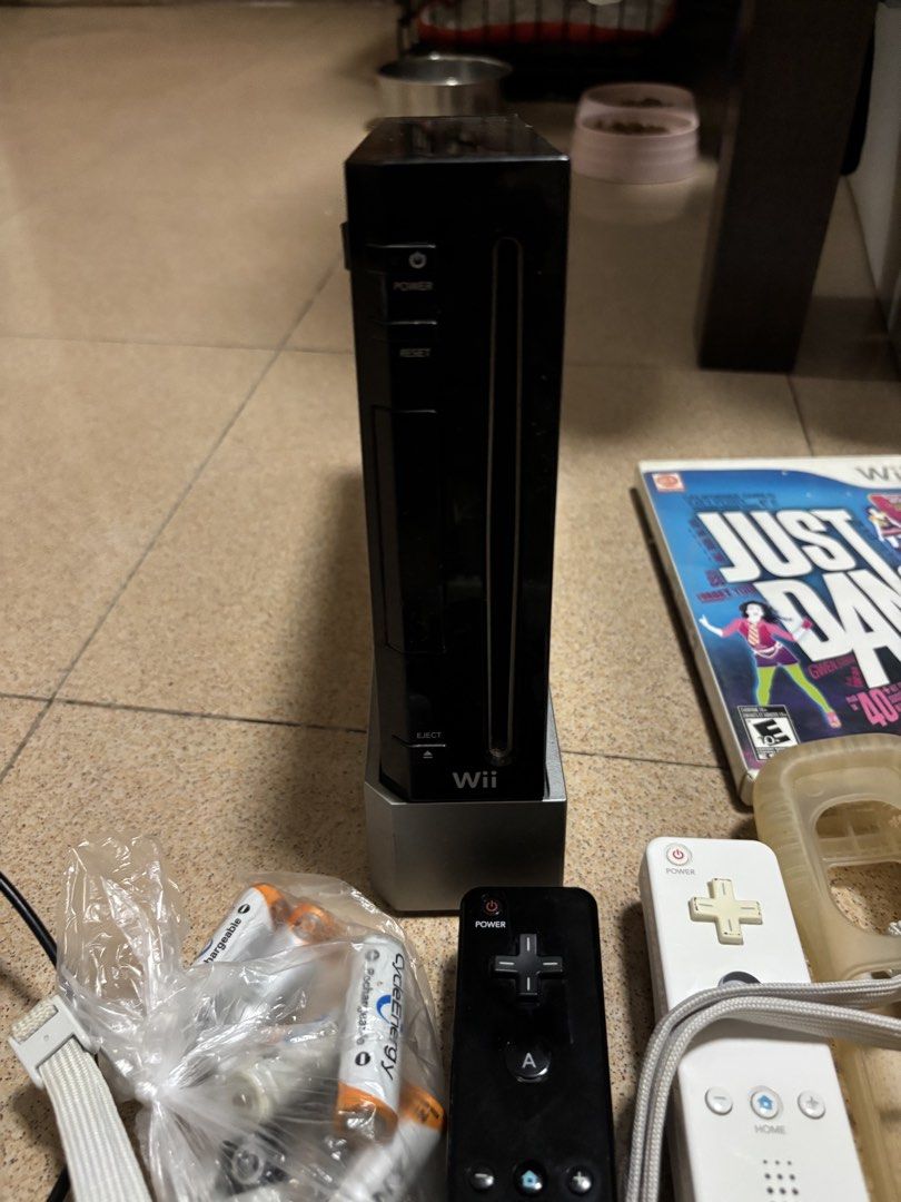 Nintendo Wii Black Console Bundle with Games and Accessories (Category: Nintendo) located in Manila. Submitted by riley523 (Listing ID 1468214365, Image 3). Description: WII FULL SET Inclusions: 1 console with stand Power cord Hdmi cord Motion sensor 2 original remote control (with additional sensor included each) 2 additional controllers 4 nunchucks 3 steering wheels Physical Games included: Mario cart Just dance 3 Wii Sports Wii sports resort F