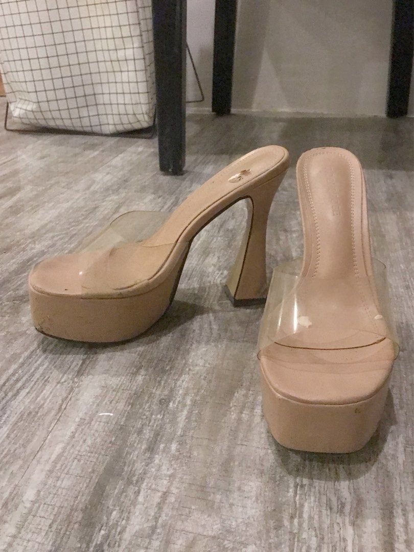 Nude Platform Clear Strap Heels (Category: Heels) located in Manila. Submitted by sparkfinds (Listing ID 1468243050, Image 2). Description: - Style: Nude platform mules with thick flared heels and clear transparent toe straps - Color: Neutral beige (goes with any outfit) - Comfort: Chunky platform design for easier walking - Condition: Pre-loved, worn multiple times - Flaws: Noticeable scuffs and peeling on the heel bases and platform edges, with