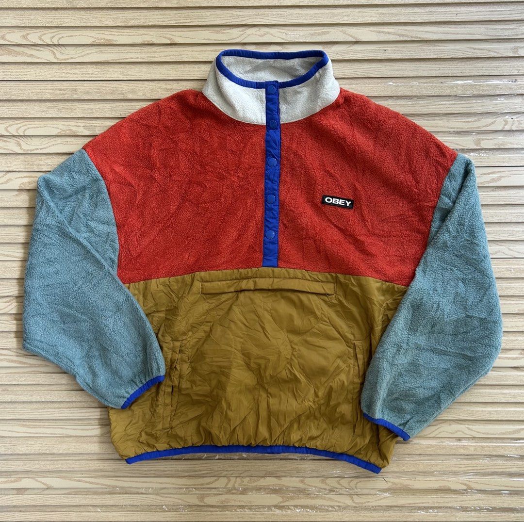OBEY Colorblock Fleece Pullover Jacket (Category: Coats, Jackets and Outerwear) located in Cagayan de Oro. Submitted by aljay02 (Listing ID 1468175135, Image 3). Description: - Brand: OBEY - Style: Multi-color block fleece pullover with snap button placket and mock neck collar - Colorway: Orange upper body, light blue sleeves, and mustard quilted lower front - Details: Small OBEY logo patch on the chest - Size: M - Measurements: Roughly 27 inches