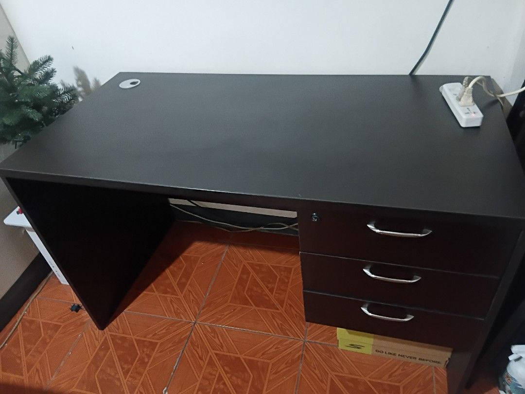 Office Table - Good condition (Category: Tables & Sets) located in Taguig. Submitted by f1d3l21 (Listing ID 1468214369, Image 2). Description: - Color: Dark brown - Features three drawers with handles and a lock - Ample surface space for work or study - Available for pickup in Taguig - Missing Drawer Key Dimension H: 73cm W: 60cm L: 120cm 1.3k negotiable.