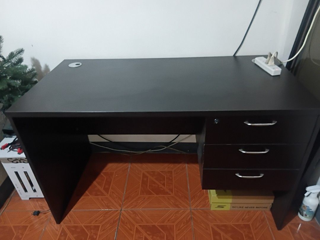 Office Table - Good condition (Category: Tables & Sets) located in Taguig. Submitted by f1d3l21 (Listing ID 1468214369, Image 1). Description: - Color: Dark brown - Features three drawers with handles and a lock - Ample surface space for work or study - Available for pickup in Taguig - Missing Drawer Key Dimension H: 73cm W: 60cm L: 120cm 1.3k negotiable.