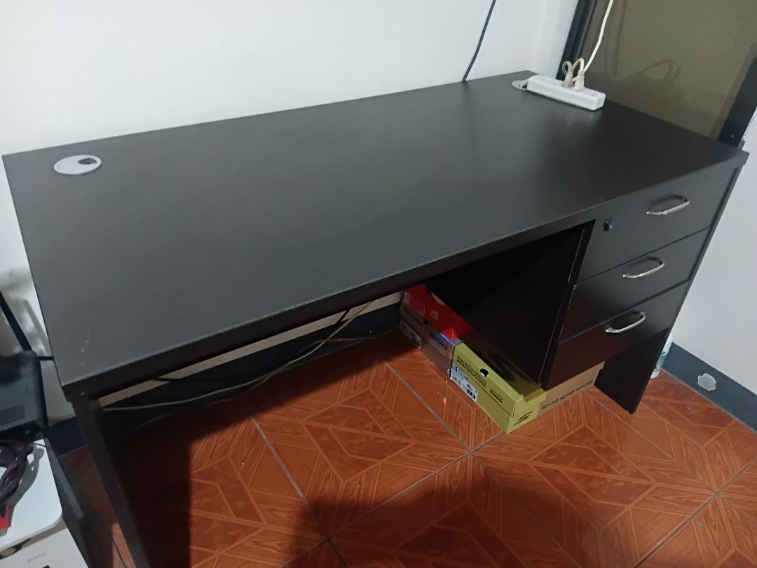 Office Table - Good condition (Category: Tables & Sets) located in Taguig. Submitted by f1d3l21 (Listing ID 1468214369, Image 3). Description: - Color: Dark brown - Features three drawers with handles and a lock - Ample surface space for work or study - Available for pickup in Taguig - Missing Drawer Key Dimension H: 73cm W: 60cm L: 120cm 1.3k negotiable.