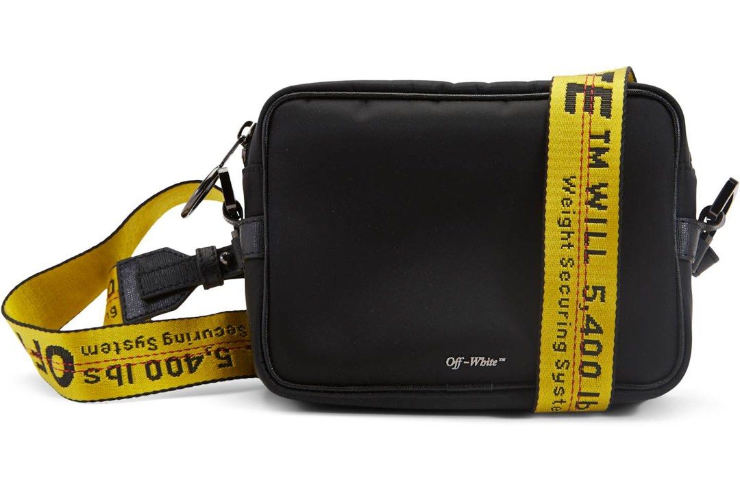 Off-White Nylon Camera Crossbody Bag with Industrial Strap (Category: Cross-body Bags) located in Manila. Submitted by shopbureau (Listing ID 1468096068, Image 2). Description: - Brand: Off-White - Material: Durable black nylon - Strap: Signature yellow industrial strap with black lettering - Hardware & Closure: Silver-tone hardware with secure zip closure - Details: Small front logo print and interior main label tag - Condition: Minimal wear, ex