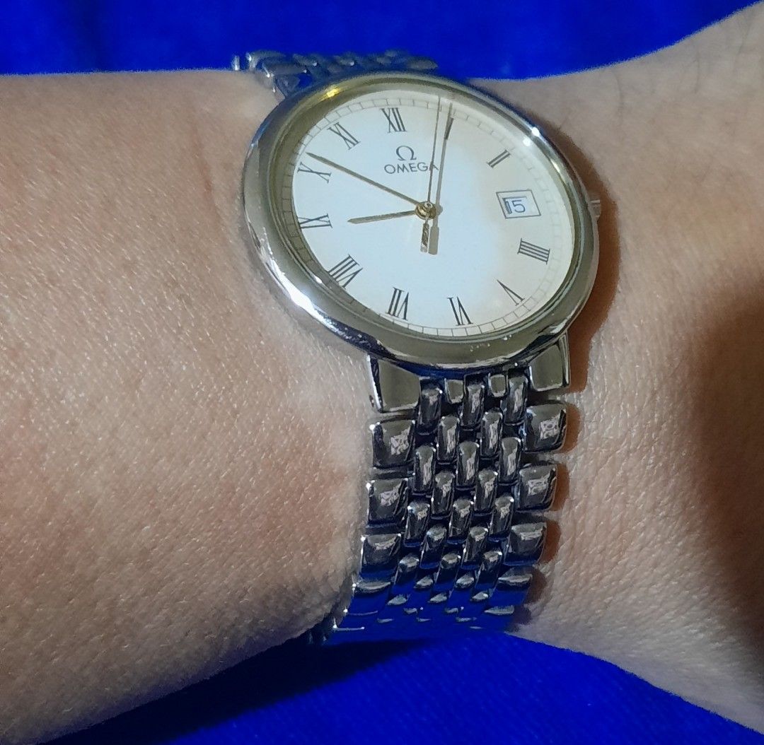 Omega De Ville Quartz Watch (Category: Luxury Watches) located in Bulacan. Submitted by ricoalba0697261 (Listing ID 1454147223, Image 1). Description: - Omega De Ville watch - Cream dial with Roman numerals - Date window at 3 o'clock - Stainless steel bracelet with signed clasp - Watch is running condition -sapphire crystal up to 6.8in.wrist.