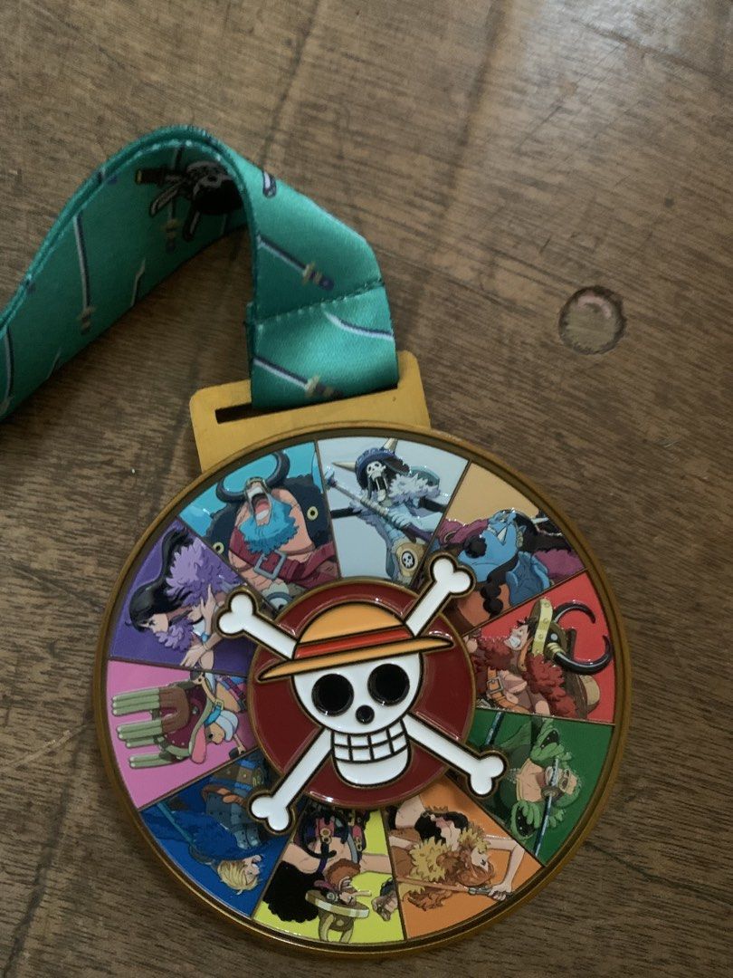 One Piece Run Philippines 5K Finisher Medal (Category: Currency) located in Caloocan City. Submitted by diannecarl32964 (Listing ID 1468091997, Image 1). Description: - Official 5K finisher medal from One Piece Run Philippines - Heavy gold-tone metal medallion featuring spinning character art on the front - Cool maze design featured on the back - Comes with the original branded '5K Finisher' lanyard - Perfect collectible for One Piece fans and ru