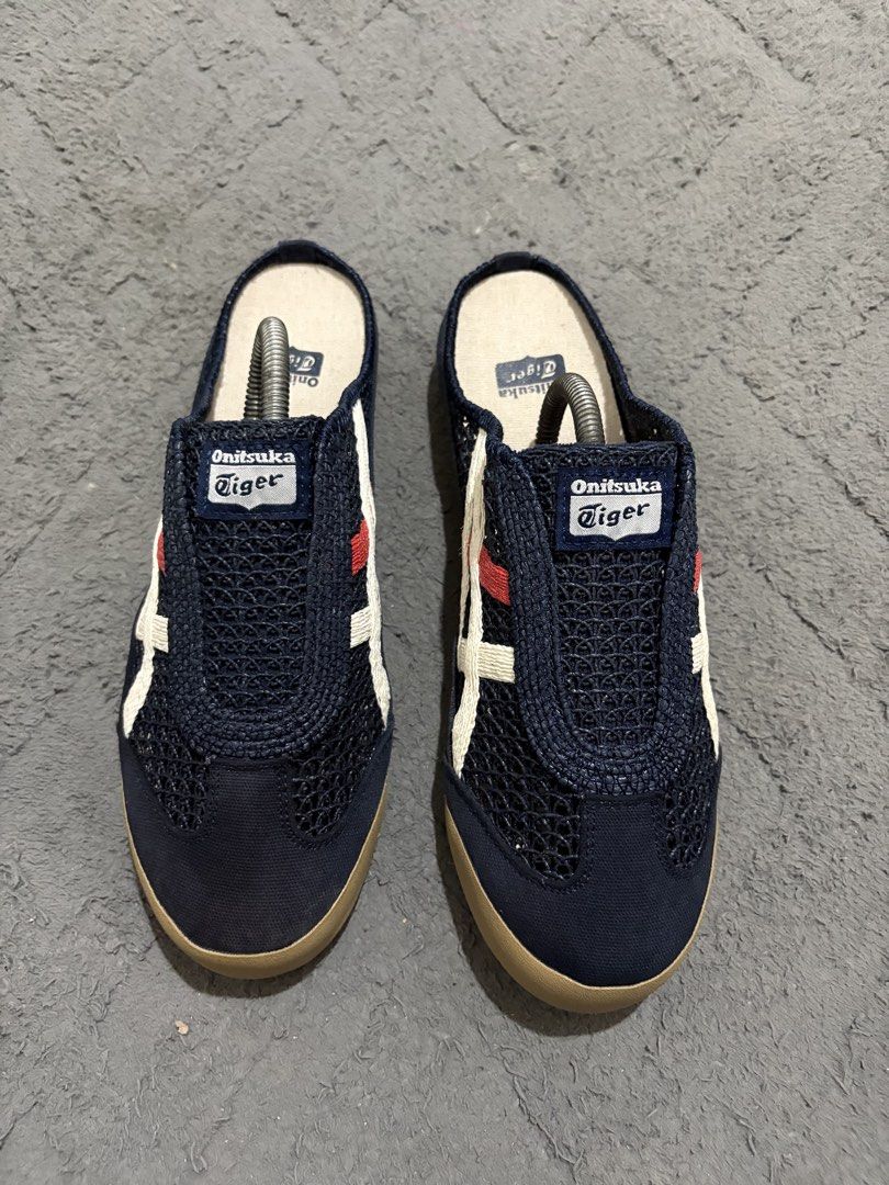 Onitsuka Tiger Mesh Slip-On Mules (Category: Slippers & Slides) located in Lapu Lapu. Submitted by jadegodine04736 (Listing ID 1468149326, Image 2). Description: - Brand: Onitsuka Tiger - Style: Slip-on mules / breathable mesh upper - Color: Navy blue with white and red side stripes, brown rubber sole - Size: US 8.5, EU 42, CM 26.5 - Condition: Clean overall with minimal wear on soles - Perfect for: Easy everyday casual wear.