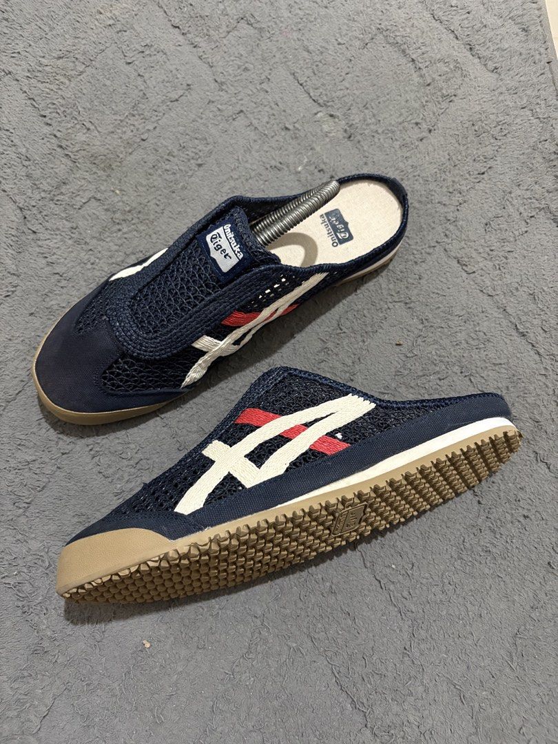 Onitsuka Tiger Mesh Slip-On Mules (Category: Slippers & Slides) located in Lapu Lapu. Submitted by jadegodine04736 (Listing ID 1468149326, Image 3). Description: - Brand: Onitsuka Tiger - Style: Slip-on mules / breathable mesh upper - Color: Navy blue with white and red side stripes, brown rubber sole - Size: US 8.5, EU 42, CM 26.5 - Condition: Clean overall with minimal wear on soles - Perfect for: Easy everyday casual wear.