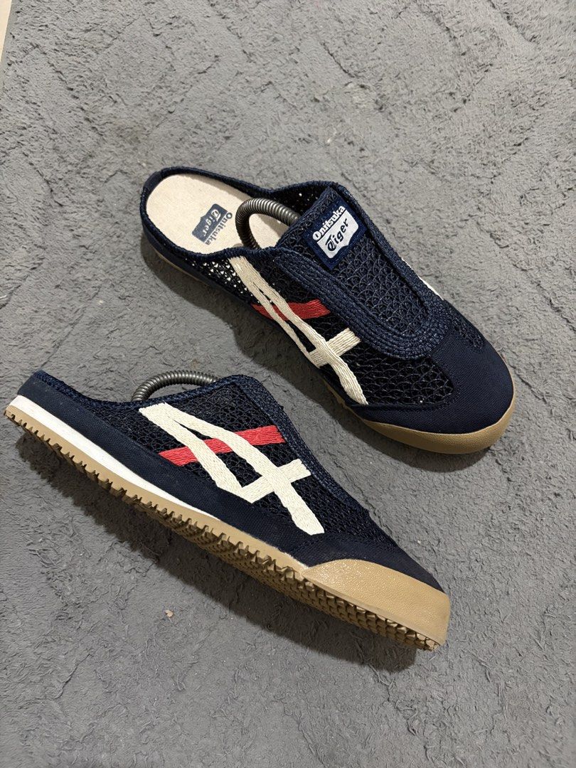 Onitsuka Tiger Mesh Slip-On Mules (Category: Slippers & Slides) located in Lapu Lapu. Submitted by jadegodine04736 (Listing ID 1468149326, Image 1). Description: - Brand: Onitsuka Tiger - Style: Slip-on mules / breathable mesh upper - Color: Navy blue with white and red side stripes, brown rubber sole - Size: US 8.5, EU 42, CM 26.5 - Condition: Clean overall with minimal wear on soles - Perfect for: Easy everyday casual wear.