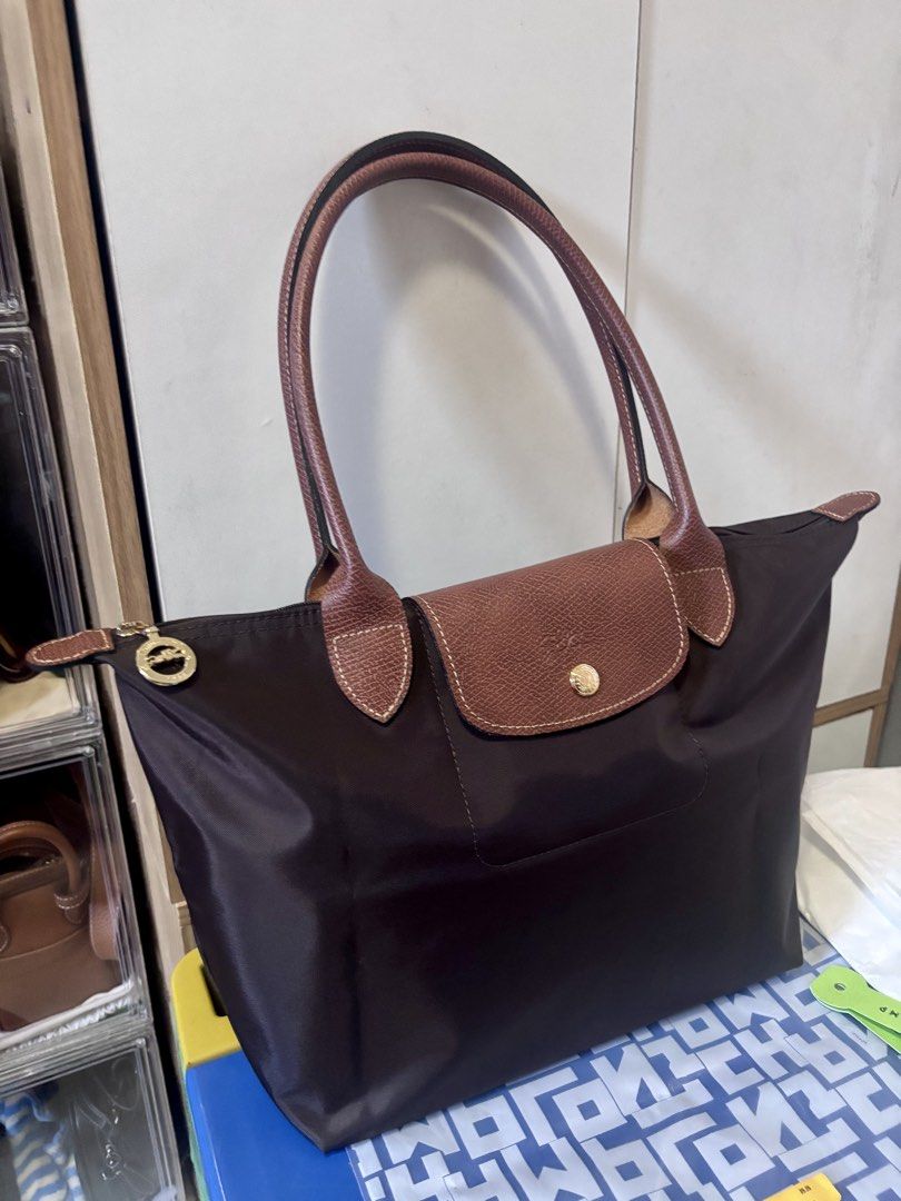 ORIGINAL & IMPORTED Longchamp Long Handle Medium Tote- Ebony (Category: Tote Bags) located in Malolos. Submitted by cheerz21 (Listing ID 1468099100, Image 2). Description: ORIGINAL & IMPORTED Longchamp Long Handle Medium Tote- Ebony Snap button Zip closure 2 inside flat pockets MINT CONDITION; Exact photos are posted Material: Canvas 26.5 cm x 28 cm x 15.5 cm 📌No return, no exchange. If in doubt, do not buy. 📌Disclaimer: Cheerz21 is not affilia