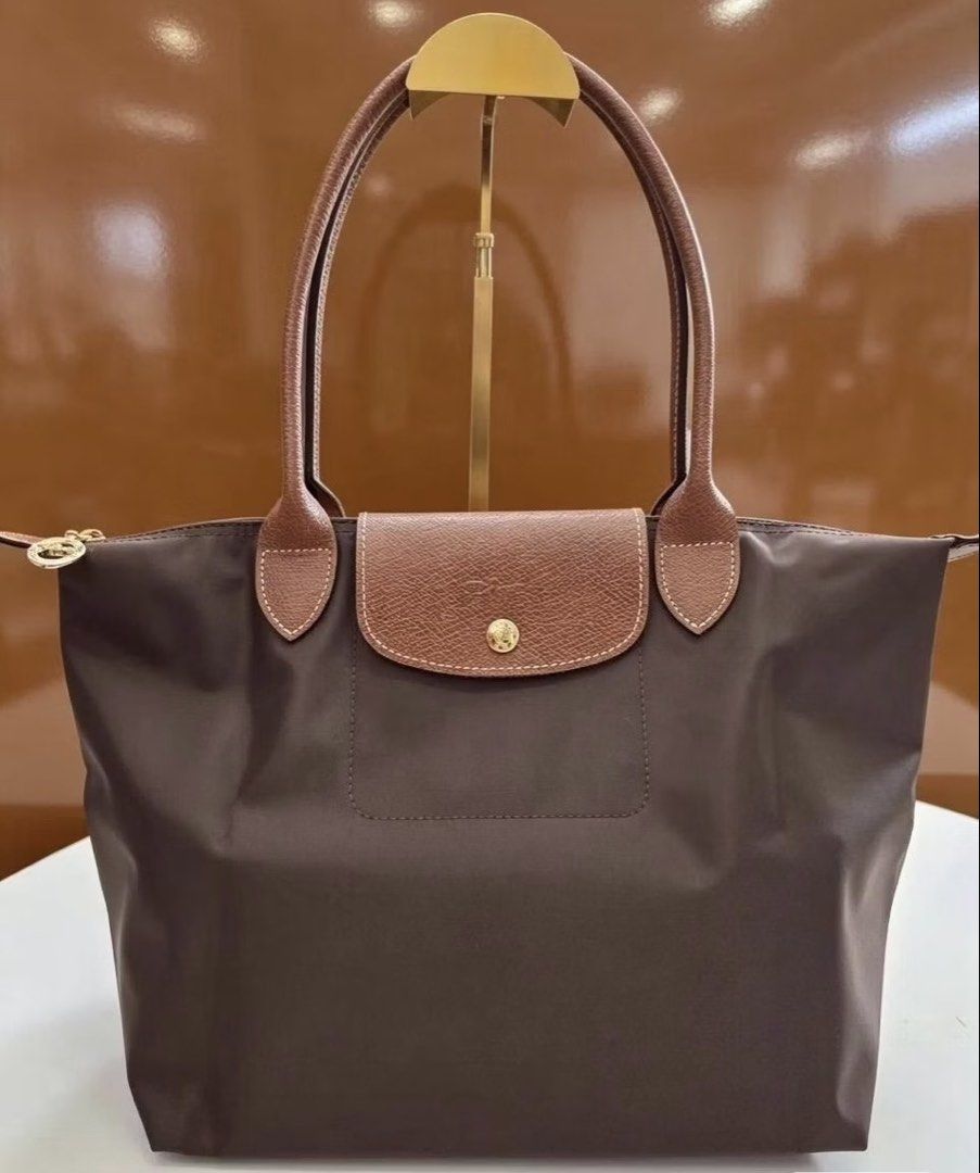 ORIGINAL & IMPORTED Longchamp Long Handle Medium Tote- Ebony (Category: Tote Bags) located in Malolos. Submitted by cheerz21 (Listing ID 1468099100, Image 1). Description: ORIGINAL & IMPORTED Longchamp Long Handle Medium Tote- Ebony Snap button Zip closure 2 inside flat pockets MINT CONDITION; Exact photos are posted Material: Canvas 26.5 cm x 28 cm x 15.5 cm 📌No return, no exchange. If in doubt, do not buy. 📌Disclaimer: Cheerz21 is not affilia