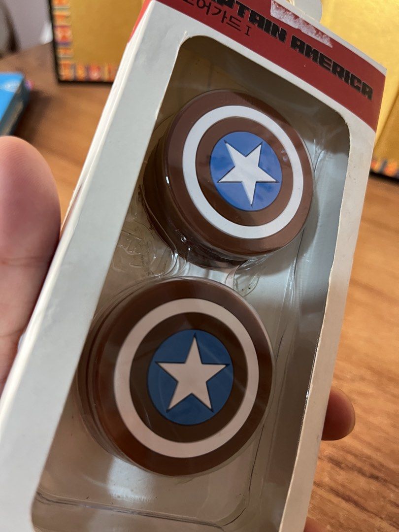 Original Marvel-branded Captain America shield analog thumbstick grip (Category: Western Merchandise) located in Gapan. Submitted by lunashop14 (Listing ID 1468070408, Image 3). Description: The image shows a set of Marvel Captain America shield silicone analog thumb stick grip caps designed for game controllers. - Official Marvel Captain America design - Protects from impacts and scratches - High-adhesion double-sided tape prevents slipping - In