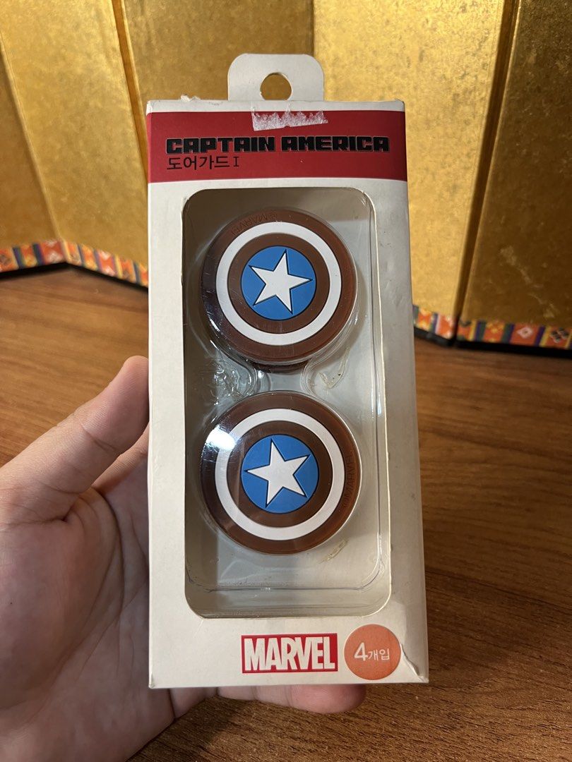 Original Marvel-branded Captain America shield analog thumbstick grip (Category: Western Merchandise) located in Gapan. Submitted by lunashop14 (Listing ID 1468070408, Image 1). Description: The image shows a set of Marvel Captain America shield silicone analog thumb stick grip caps designed for game controllers. - Official Marvel Captain America design - Protects from impacts and scratches - High-adhesion double-sided tape prevents slipping - In