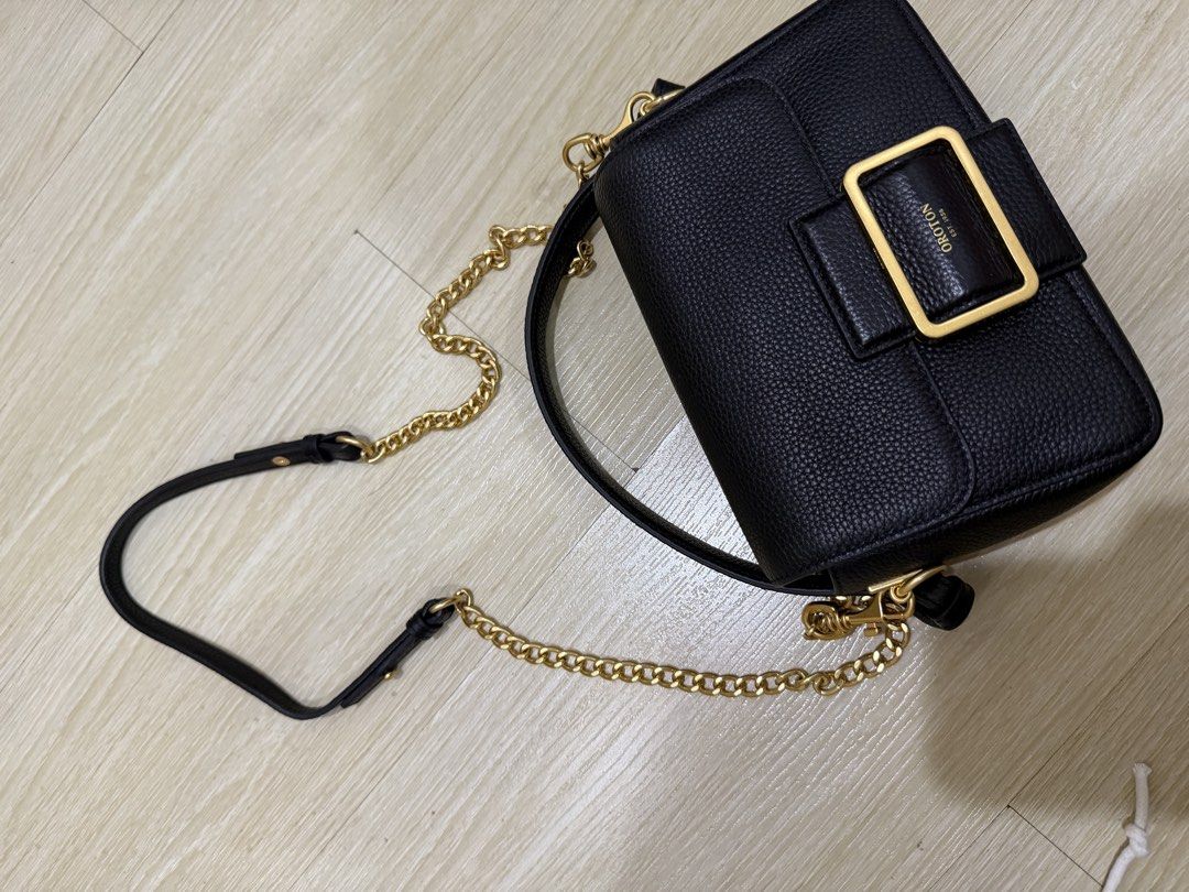 Oroton Astrid Crossbody Bag Black (Category: Cross-body Bags) located in Taguig. Submitted by preloved.by.diane (Listing ID 1468242701, Image 3). Description: - Brand: Oroton - Style: Astrid Crossbody - Material: Black pebble leather - Hardware: Gold - Closure: Front buckle with magnetic snap - Strap: Adjustable chain and leather - Interior: Clean lining with open main compartment - Condition: Brand new, unused with original $399 tag attached.