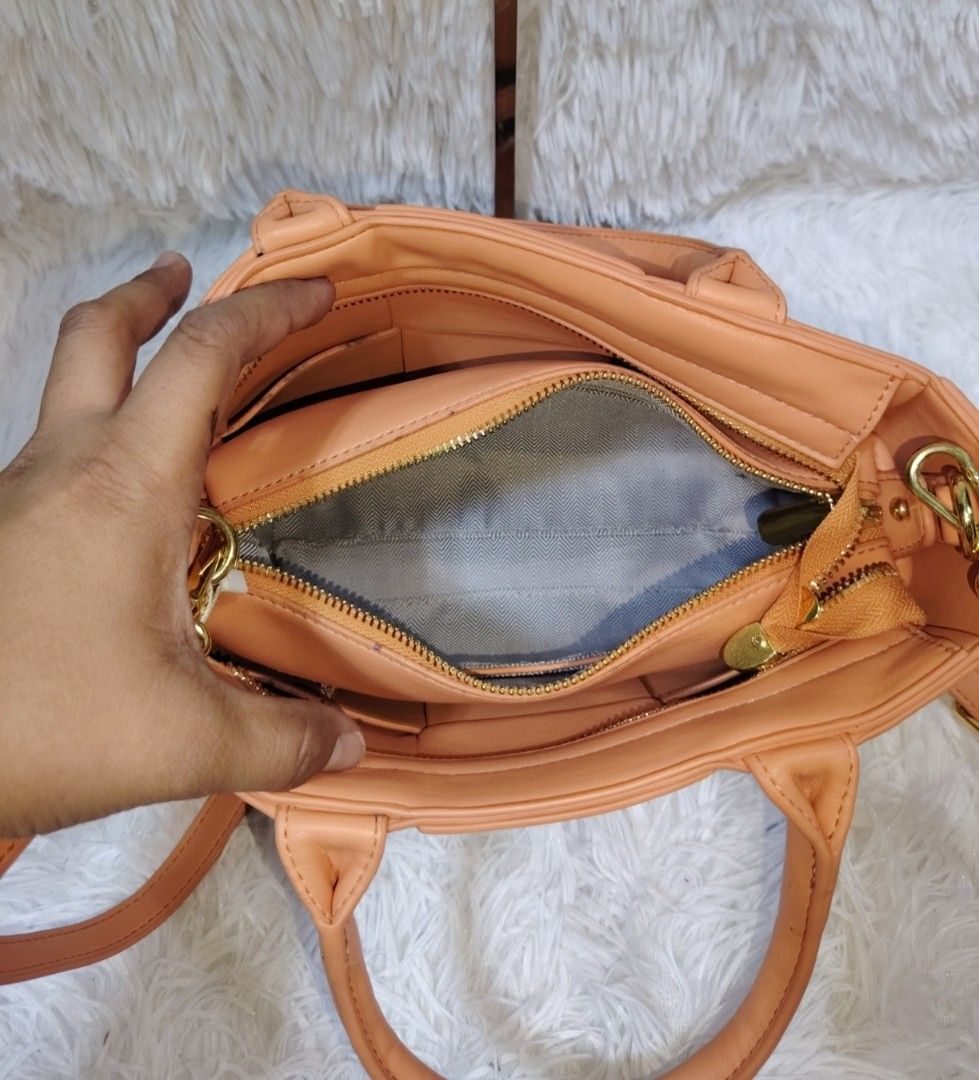 Oroton Monogram Shoulder Bag (Category: Shoulder Bags) located in Quezon City. Submitted by zhelcloset01 (Listing ID 1468060656, Image 2). Description: - Authentic Oroton monogram canvas shoulder bag - Sleek black leather trim and handles - Elegant silver-toned hardware rings - Dark patterned fabric lining with an internal zippered pocket - Includes a chic matching hanging ring charm - Condition: Excellent/Pre-loved (ready to use) - Perfect for d