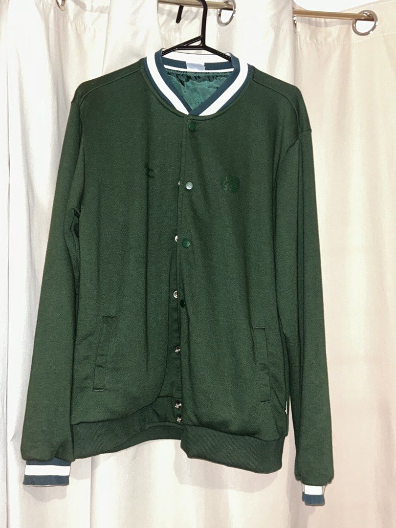 Oxygen Varsity Jacket Green Size S (Category: Coats, Jackets and Outerwear) located in Dasmarinas. Submitted by brandedstuff.est2022 (Listing ID 1468166673, Image 1). Description: - Brand/Model: Oxygen Premium Threads - Size: S - Color: Deep green - Closure: Button-up front with snap buttons - Details: Striped ribbed collar, cuffs, and hem - Lining: Green satin inside - Pockets: Two functional front pockets - Branding: Small debossed logo on the 