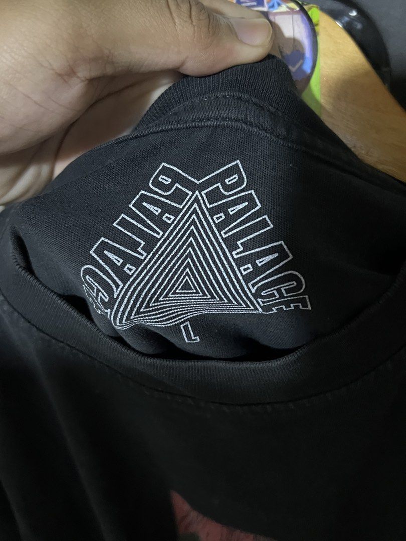 Palace Trust No Snakes Black Tee Size L (Category: Tshirts & Polo Shirts ) located in Davao. Submitted by thriftitemsss (Listing ID 1468196705, Image 2). Description: - Brand: Palace Skateboards - Style: Trust T-Shirt - Color: Black - Size: Large (L) - Material: 100% Cotton - Design: Large front graphic with snake and red cross, 'No Snakes' text on left sleeve, and classic Tri-Ferg logo on inner collar - Condition: Pre-owned, has a couple of tiny