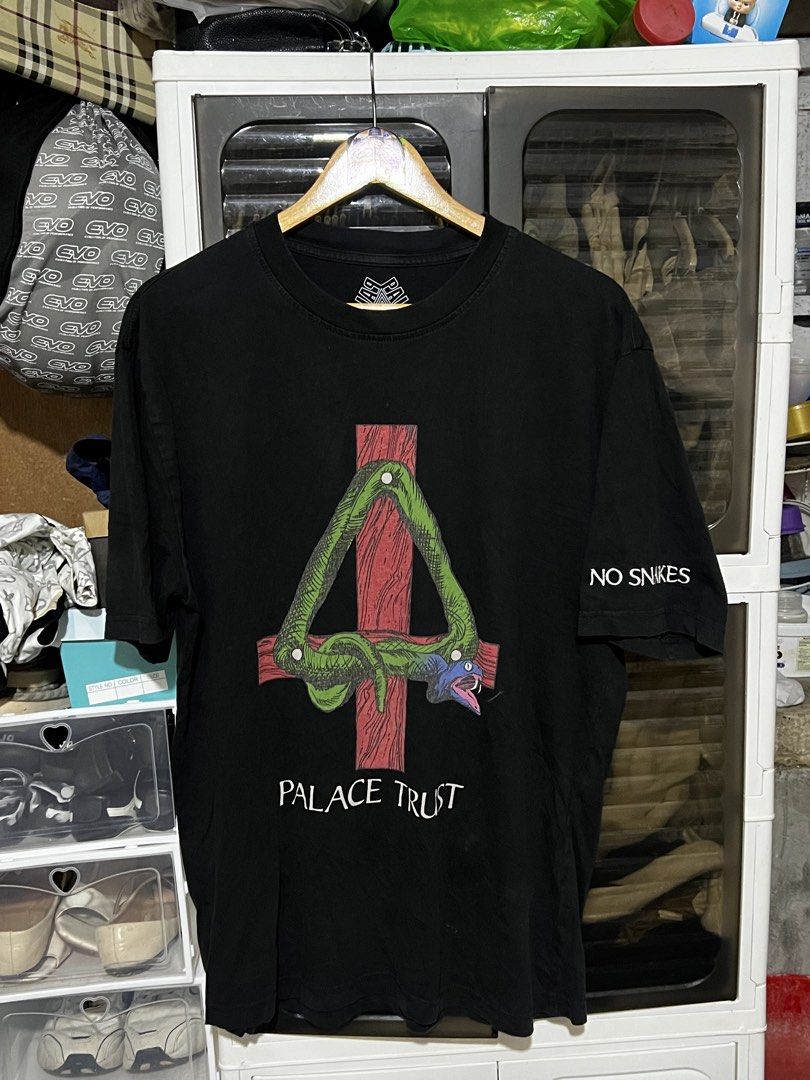 Palace Trust No Snakes Black Tee Size L (Category: Tshirts & Polo Shirts ) located in Davao. Submitted by thriftitemsss (Listing ID 1468196705, Image 1). Description: - Brand: Palace Skateboards - Style: Trust T-Shirt - Color: Black - Size: Large (L) - Material: 100% Cotton - Design: Large front graphic with snake and red cross, 'No Snakes' text on left sleeve, and classic Tri-Ferg logo on inner collar - Condition: Pre-owned, has a couple of tiny