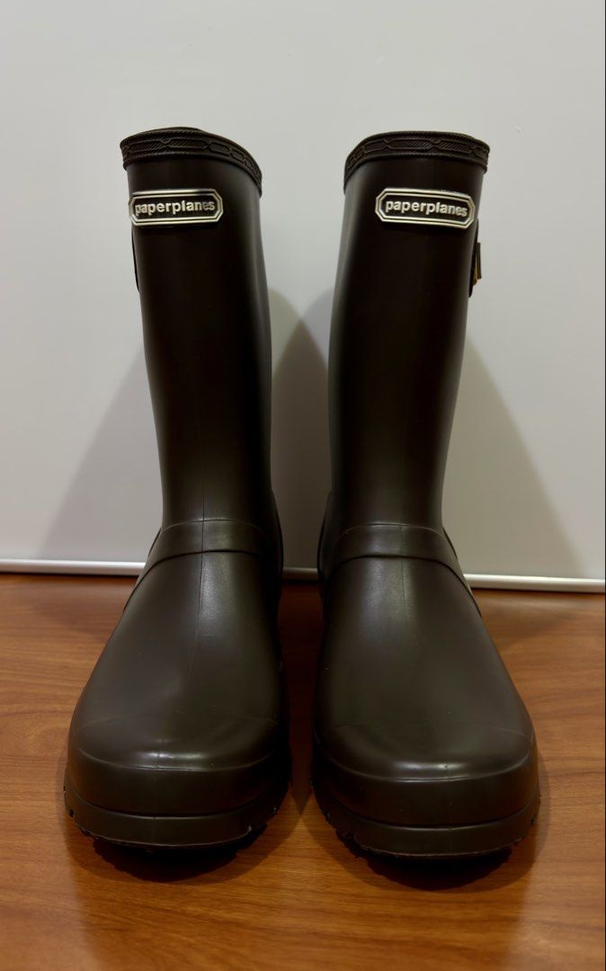 PaperplanesTall Rubber Rain Boots – Dark Brown (Category: Boots) located in Binangonan. Submitted by c_r_i_s (Listing ID 1468279149, Image 3). Description: Paperplanes Tall Rubber Rain Boots – Dark Brown Classic dark brown rain boots with gold-tone side buckle details, patterned fabric lining, and thick, textured soles. Practical for rainy days, gardening, and outdoor errands. Minor surface marks are visible; sole treads are well defined. Please 