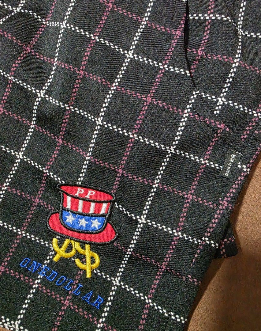 Paul Friend Plaid Shorts Size L (Category: Shorts) located in Paranaque City. Submitted by franinnashop (Listing ID 1468097403, Image 3). Description: Declutter 28 to 32 paranaque city - Brand: Paul Frank - Color: Black with white and pink plaid grid pattern - Size: L (fits waist 28 to 32 inches) - Waistband: Elastic with branded metal grommets - Details: Uncle Sam top hat patch and dollar sign graphic with 'ONEDOLLAR' text on the leg - Features: