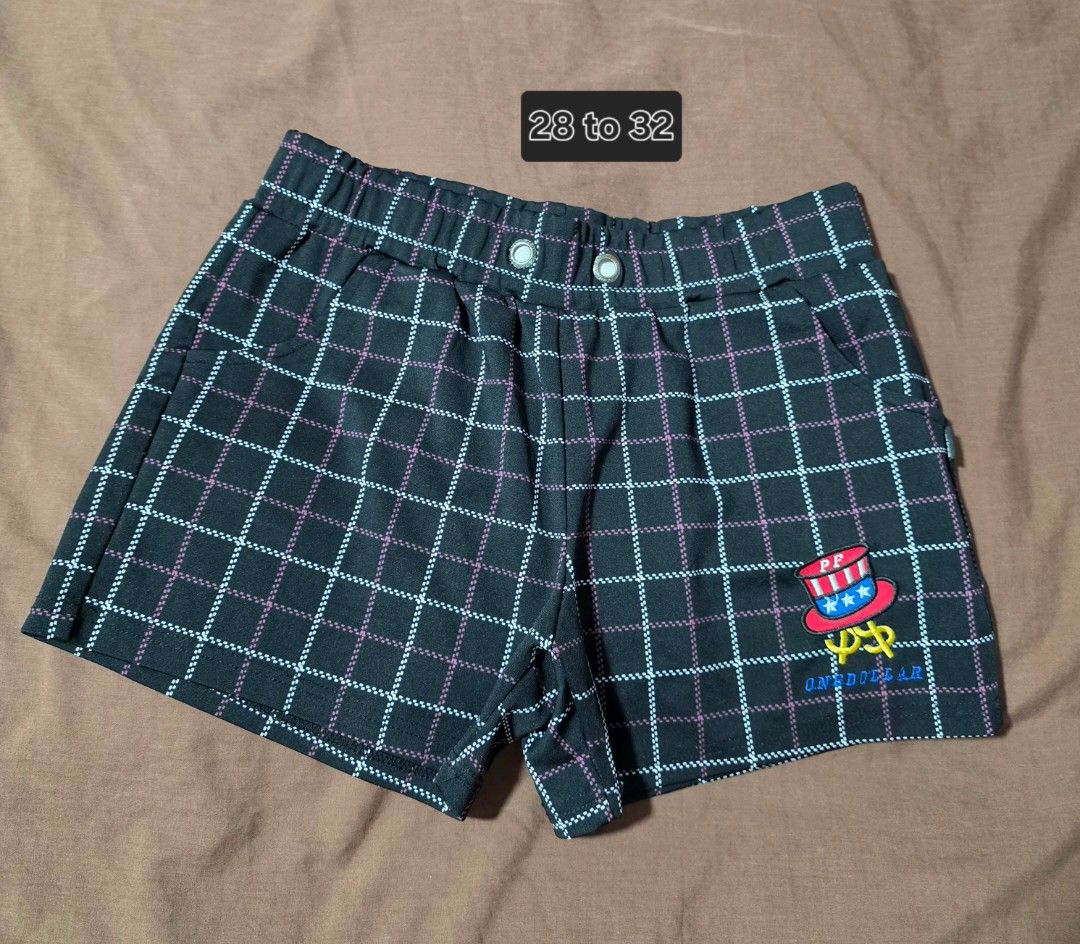 Paul Friend Plaid Shorts Size L (Category: Shorts) located in Paranaque City. Submitted by franinnashop (Listing ID 1468097403, Image 1). Description: Declutter 28 to 32 paranaque city - Brand: Paul Frank - Color: Black with white and pink plaid grid pattern - Size: L (fits waist 28 to 32 inches) - Waistband: Elastic with branded metal grommets - Details: Uncle Sam top hat patch and dollar sign graphic with 'ONEDOLLAR' text on the leg - Features:
