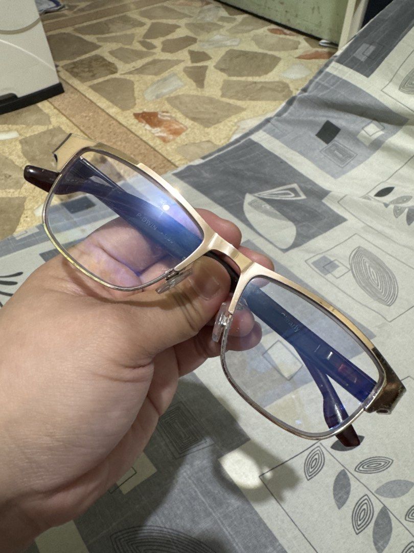 P-DWIN +1.50 Reading Glasses Gold Frame (Category: Sunglasses & Eyewear) located in Quezon City. Submitted by big_fat_momma (Listing ID 1468069227, Image 1). Description: - Brand: P-DWIN - Strength: +1.50 (marked clearly on temple arm) - Frame: Lightweight gold metal frame with dark brown arms - Lenses: Rectangular with blue tint coating - Comfort: Includes attached nose pads - Condition: Clean, well-maintained.