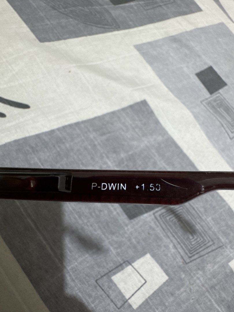 P-DWIN +1.50 Reading Glasses Gold Frame (Category: Sunglasses & Eyewear) located in Quezon City. Submitted by big_fat_momma (Listing ID 1468069227, Image 2). Description: - Brand: P-DWIN - Strength: +1.50 (marked clearly on temple arm) - Frame: Lightweight gold metal frame with dark brown arms - Lenses: Rectangular with blue tint coating - Comfort: Includes attached nose pads - Condition: Clean, well-maintained.