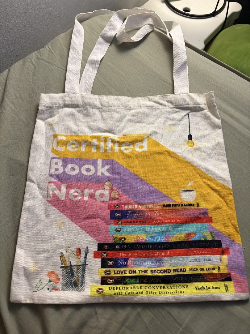 Penguin Random House SEA Tote Bag (Category: Tote Bags) located in Manila. Submitted by ajdeclutter (Listing ID 1468192300, Image 1). Description: - Authentic Penguin Random House SEA tote bag - Design: 'Certified Book Nerd' on front, 'Fiction Frenzy' on back with colorful book graphics - Condition: Clean, no stains or damage found .
