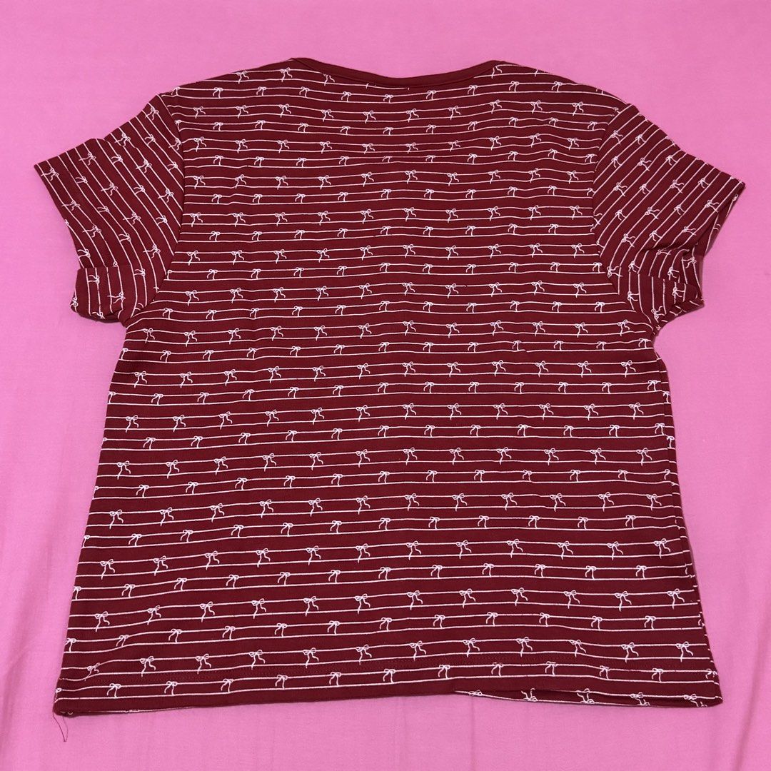 Penshoppe Slim Fit Maroon Top (Category: Shirts) located in San Fernando. Submitted by declotter (Listing ID 1468088834, Image 2). Description: - Brand: Penshoppe - Size: M - Color: Maroon red with white stripes and tiny bow print - Fit: Slim fit with scoop neckline and full front button placket - Style: Cute coquette vibe, perfect everyday basic - Condition: Excellent, no damage or flaws found.