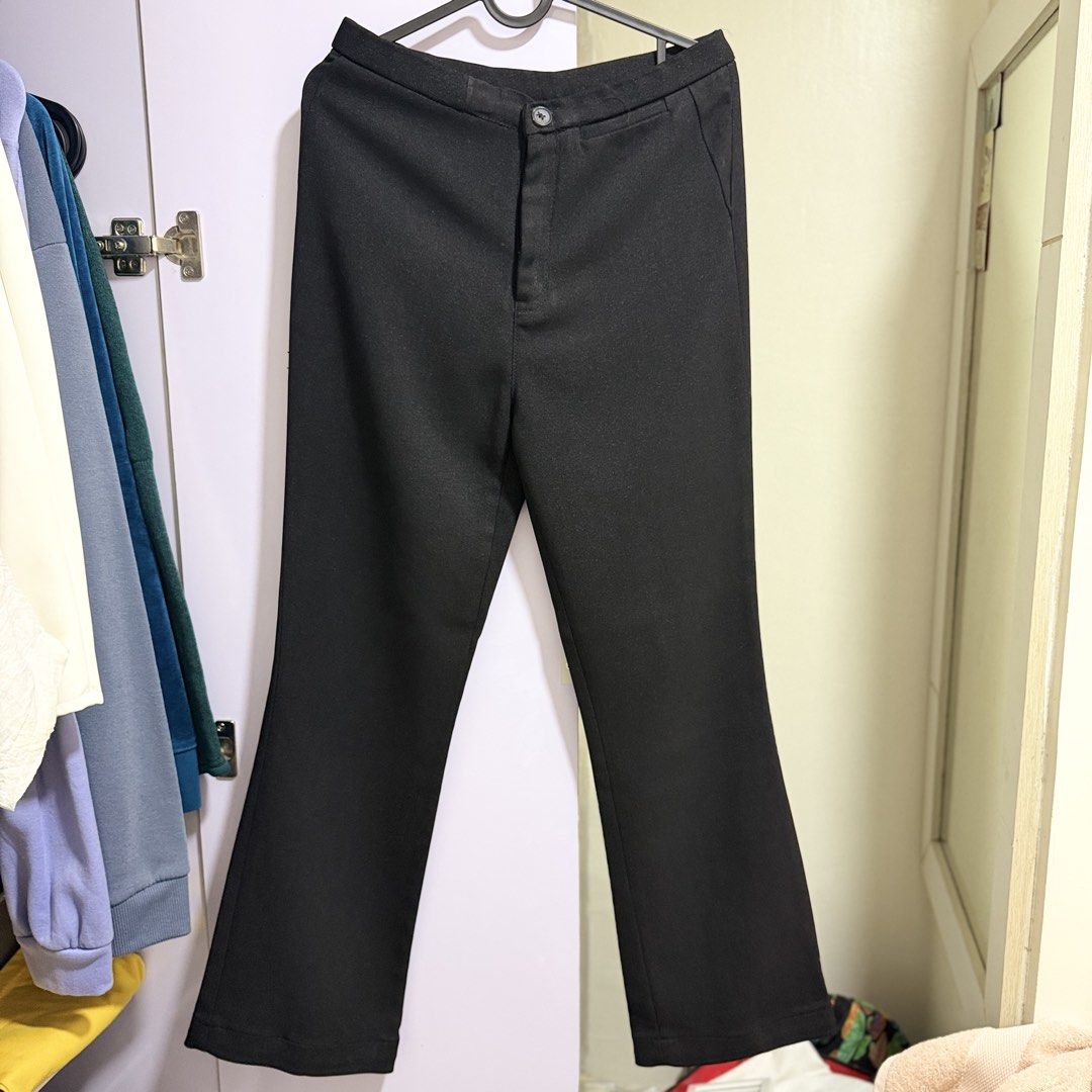 perry ellis black trousers flare pants (Category: Other Bottoms) located in Cavite. Submitted by lovedbysham (Listing ID 1468275232, Image 1). Description: - Brand: Perry Ellis - Color: Classic solid black - Design: Structured waistline with front button closure and slightly flared hem - Style: Versatile and timeless - Occasion: Perfect for both casual outings and work wear - Matching: Great basic piece that pairs easily with any top.