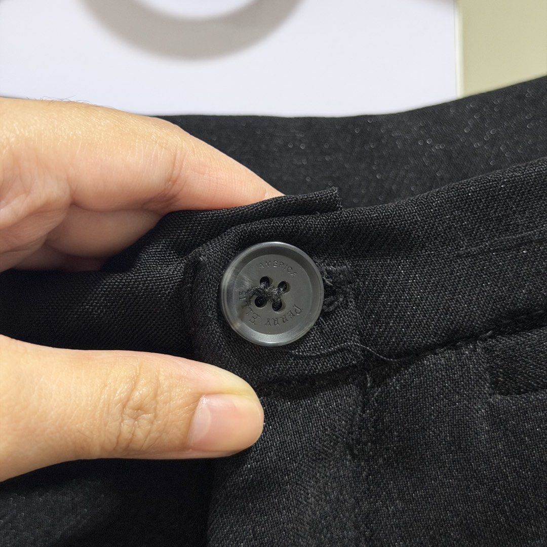 perry ellis black trousers flare pants (Category: Other Bottoms) located in Cavite. Submitted by lovedbysham (Listing ID 1468275232, Image 2). Description: - Brand: Perry Ellis - Color: Classic solid black - Design: Structured waistline with front button closure and slightly flared hem - Style: Versatile and timeless - Occasion: Perfect for both casual outings and work wear - Matching: Great basic piece that pairs easily with any top.