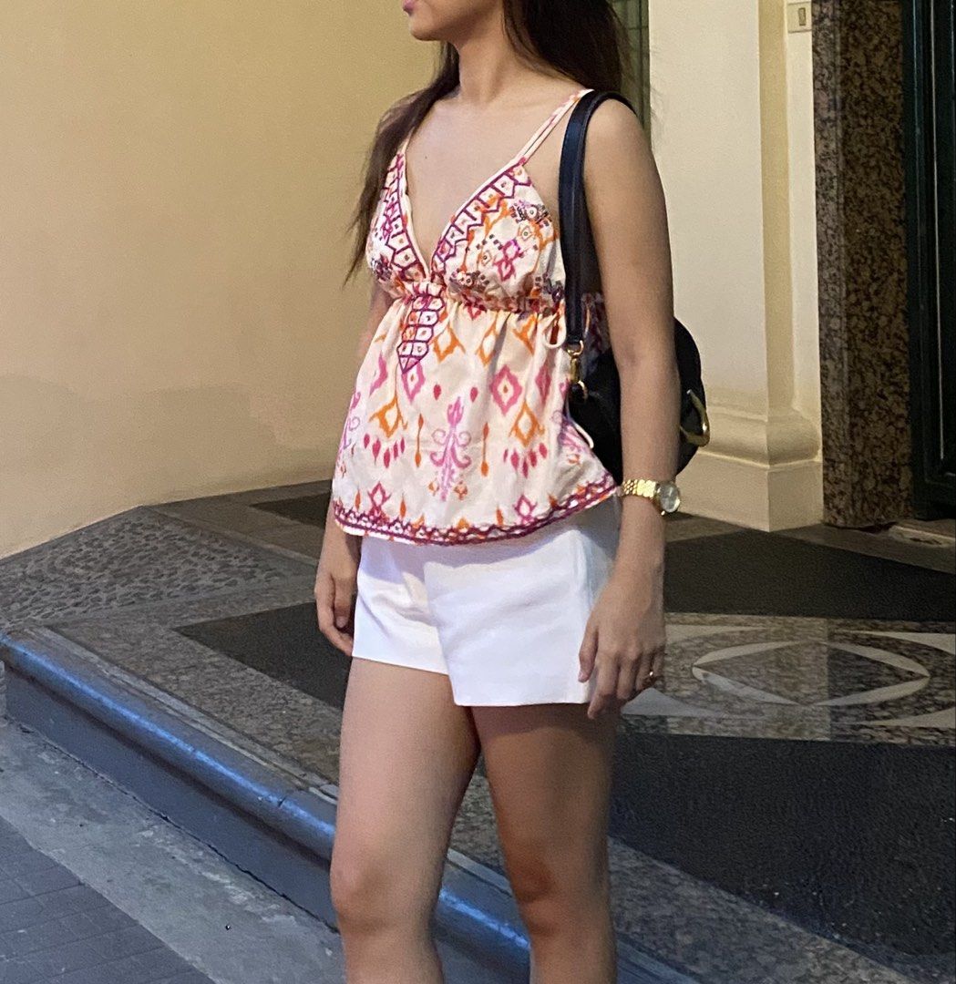 Pink and Orange Patterned Spaghetti Strap Camisole Top (Category: Sleeveless) located in Manila. Submitted by saudadeee (Listing ID 1468102393, Image 1). Description: - Style: Sleeveless cami with a flattering flowy fit - Design: Vibrant pink, orange, and purple geometric pattern - Details: Deep V-neckline and thin adjustable spaghetti straps - Material: Lightweight fabric, perfect for hot weather - Versatility: Easy to pair with white shorts or 