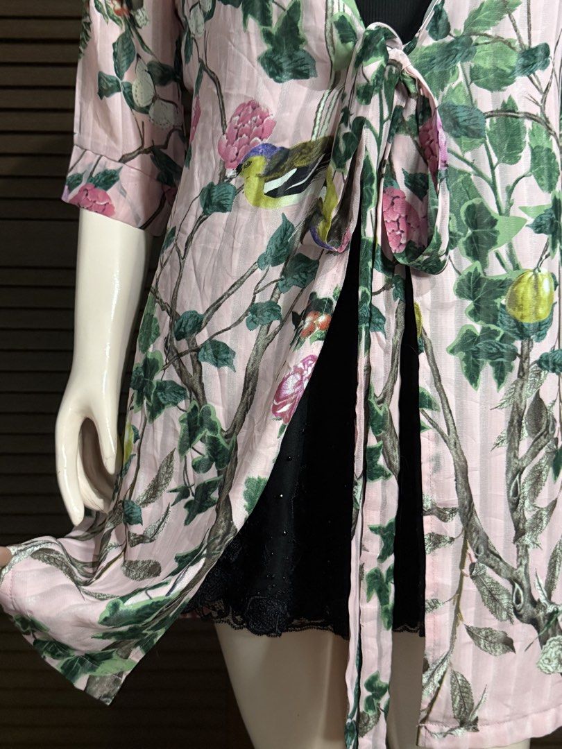 Pink Floral Tree Print Tie-Front Cardigan (Category: Coats, Jackets and Outerwear) located in Santiago. Submitted by jy.collection (Listing ID 1468089451, Image 3). Description: - Color/Design: Pink with all-over tree and flower print - Sleeves: Half sleeves - Closure: Front tie closure with long straps - Material: Soft, sheer fabric - Styling: Great layering piece over basic tops - Condition: Excellent / Pre-loved (ready to wear).