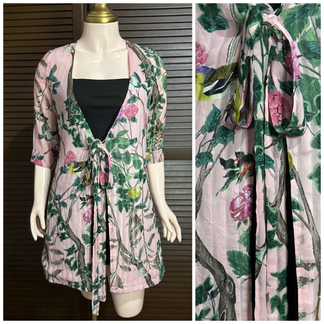 Pink Floral Tree Print Tie-Front Cardigan (Category: Coats, Jackets and Outerwear) located in Santiago. Submitted by jy.collection (Listing ID 1468089451, Image 1). Description: - Color/Design: Pink with all-over tree and flower print - Sleeves: Half sleeves - Closure: Front tie closure with long straps - Material: Soft, sheer fabric - Styling: Great layering piece over basic tops - Condition: Excellent / Pre-loved (ready to wear).