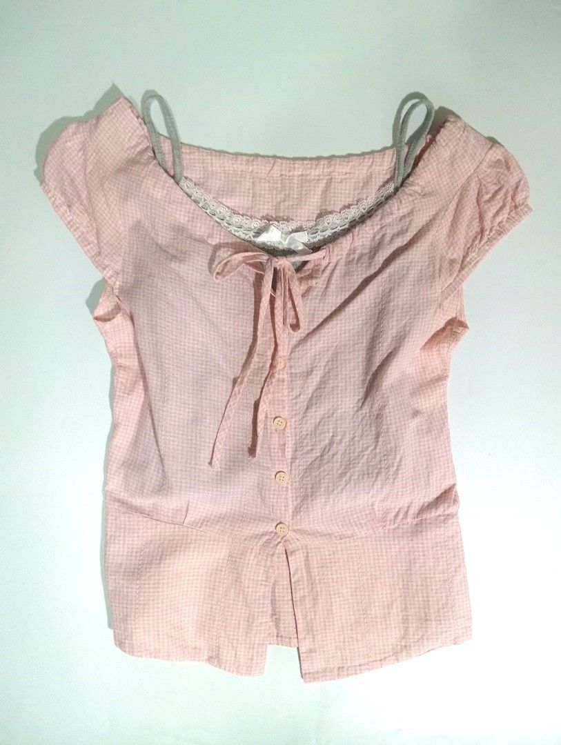 Pink Gingham Button-Front Blouse with Lace Trim (Category: Blouses) located in Muntinlupa City. Submitted by kryztelle.tidal (Listing ID 1468118068, Image 2). Description: - Color/Pattern: Pink and white gingham - Fit: Fitted silhouette with a flared hem - Details: Front button closure, lace-trimmed neckline with string ties - Styling: Layering-friendly design.