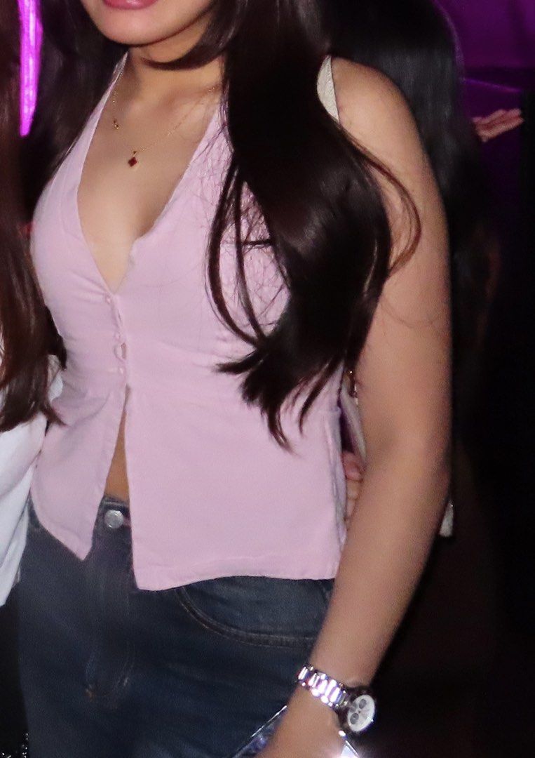 Pink halter neck vest top with buttons (Category: Sleeveless) located in Manila. Submitted by cpaa.aaa (Listing ID 1468138656, Image 2). Description: Light pink Halter neck sleeveless deep V-neck Size: S-M.