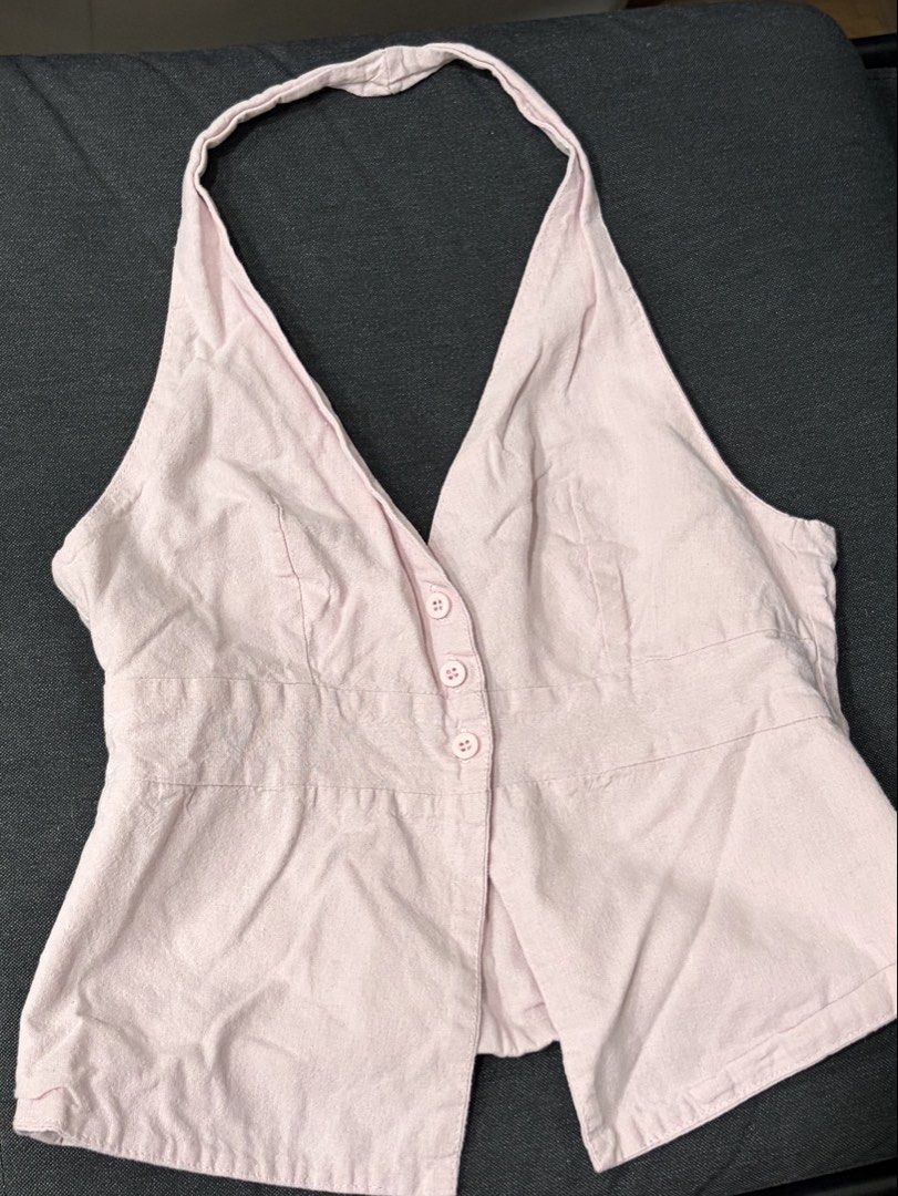 Pink halter neck vest top with buttons (Category: Sleeveless) located in Manila. Submitted by cpaa.aaa (Listing ID 1468138656, Image 1). Description: Light pink Halter neck sleeveless deep V-neck Size: S-M.