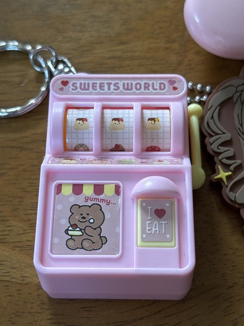 Pink Items bundle: slot-machine charm, retractable ID holder, anime charm (Category: Other Merchandise) located in Calamba. Submitted by cur8d (Listing ID 1468105664, Image 2). Description: .