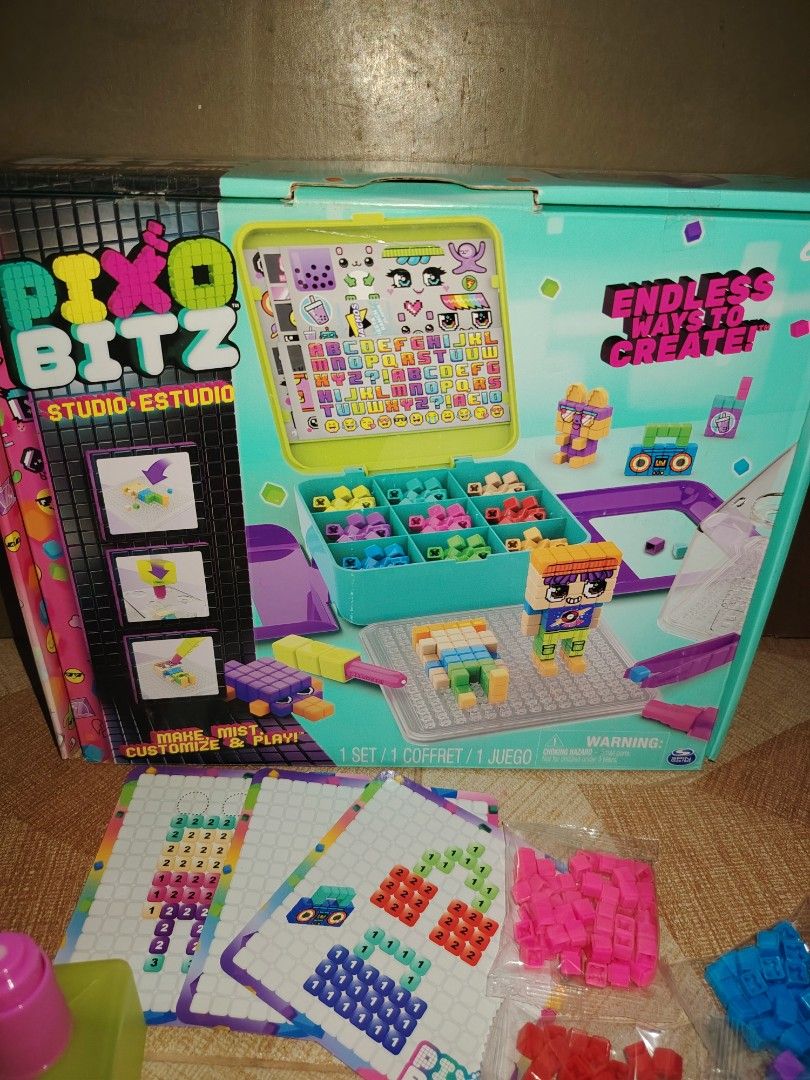 Pixobitz Studio Water Fuse Beads Craft Kit (Category: Craft Supplies & Tools) located in Santiago. Submitted by aceheart0118672 (Listing ID 1468178506, Image 3). Description: - Pixobitz Studio 3D water fuse bead kit for kids - Includes colorful bead packs, templates, spray bottle, tools, and storage case - Original box and instruction booklet included - Fun and engaging creative activity.