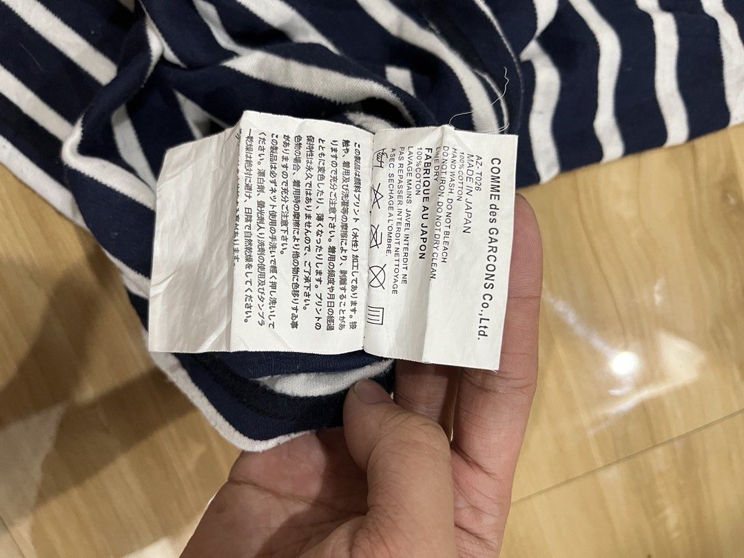 PLAY Comme des Garçons Striped Tank Top (Category: Sleeveless) located in Angeles City. Submitted by thriftsij (Listing ID 1468242230, Image 2). Description: - Brand: Comme des Garçons Play -Xs 13.5x26 - Design: Navy and white horizontal stripes with racerback style - Detail: Signature red heart patch on the chest - Made in Japan - Condition: Excellent condition.