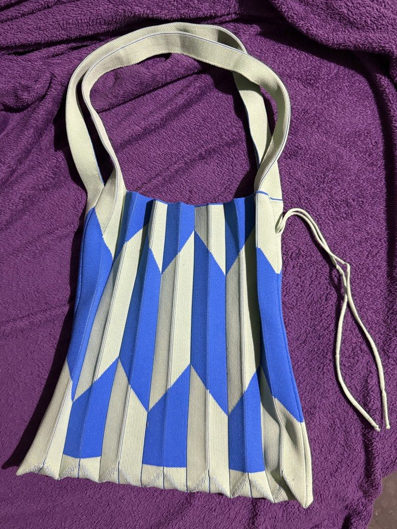 Pleated Knit Expandable Shoulder Bag (Category: Tote Bags) located in Tarlac. Submitted by declutterwithawd (Listing ID 1468217770, Image 2). Description: -SM Axcs - Vibrant pleated knit tote in bright blue and light green - Stylish geometric chevron pattern - Soft, stretchy, and lightweight material - Comfortable shoulder straps for everyday wear - Includes a matching drawstring to cinch the top or pack the bag flat - Easy to fold and stash insi