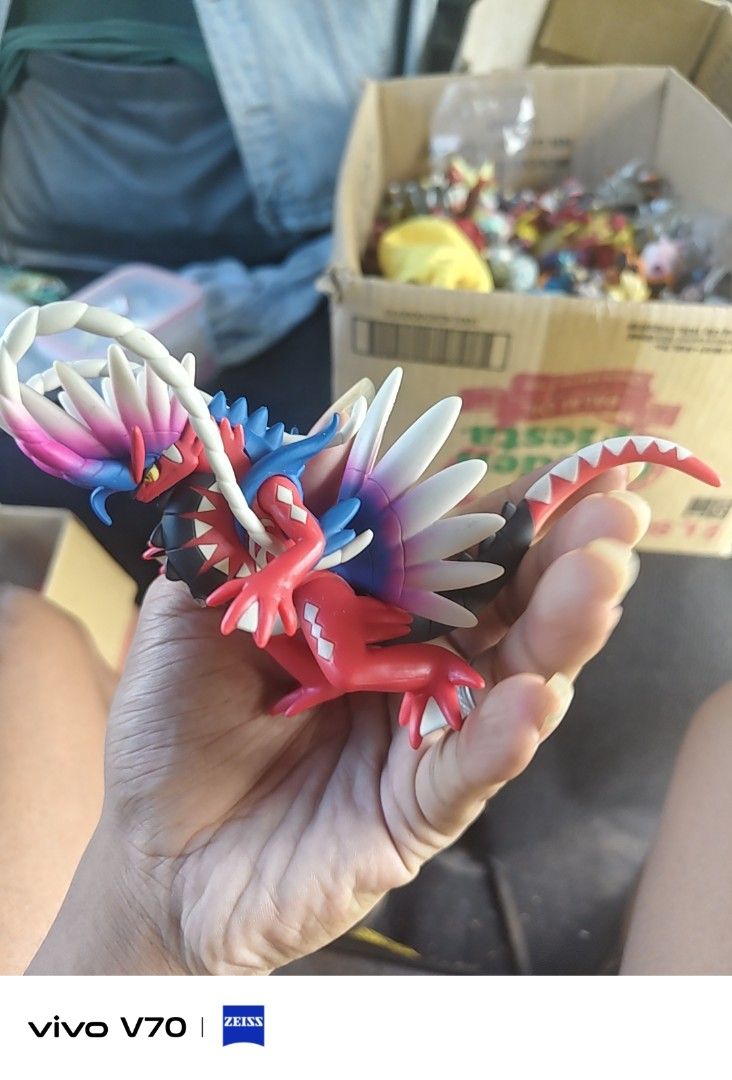 Pokemon Koraidon Figure (Category: Figurines & Statues) located in Kapangan. Submitted by ClumZyDale (Listing ID 1468084454, Image 3). Description: - Pokémon: Koraidon (Pokémon Scarlet and Violet) - Design: Highly detailed sculpt with vibrant red body, white feathers, and blue accents - Display: Stands on its own, perfect for desks or shelves - Condition: Loose item, no box included.