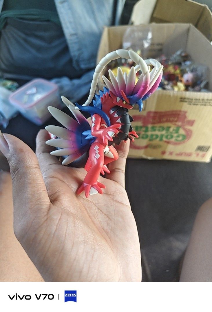 Pokemon Koraidon Figure (Category: Figurines & Statues) located in Kapangan. Submitted by ClumZyDale (Listing ID 1468084454, Image 1). Description: - Pokémon: Koraidon (Pokémon Scarlet and Violet) - Design: Highly detailed sculpt with vibrant red body, white feathers, and blue accents - Display: Stands on its own, perfect for desks or shelves - Condition: Loose item, no box included.