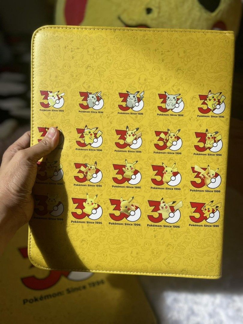 Pokemon Pikachu 3rd Anniversary Trading Card Binder (Category: Trading Cards Accessories) located in Quezon City. Submitted by jiglieshop (Listing ID 1468063497, Image 3). Description: - Vibrant yellow Pokémon TCG binder featuring an eye-catching Pikachu and number 3 cover design - Secure zip-around closure with a convenient black handle strap for easy carrying - Durable 3-ring metal binder mechanism with built-in card sleeves and a bonus pack of