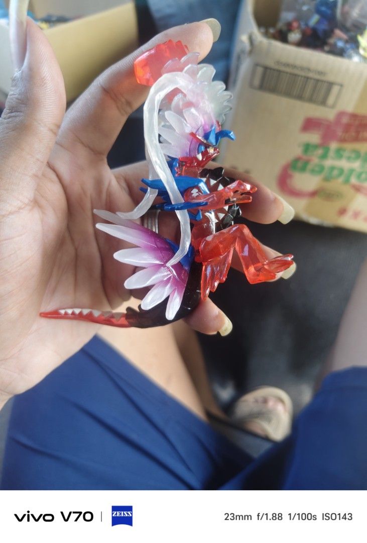 Pokémon Koraidon Terastal Phenomenon Figure (Category: Figurines & Statues) located in Kapangan. Submitted by ClumZyDale (Listing ID 1468082721, Image 2). Description: - Authentic Pokémon Koraidon display figure - Features striking translucent red, white, and blue crystal details - Clear plastic effect parts on the head and tail for a dynamic look - Intricately sculpted scales and spikes along the back - Perfect size for desktop or shelf display 