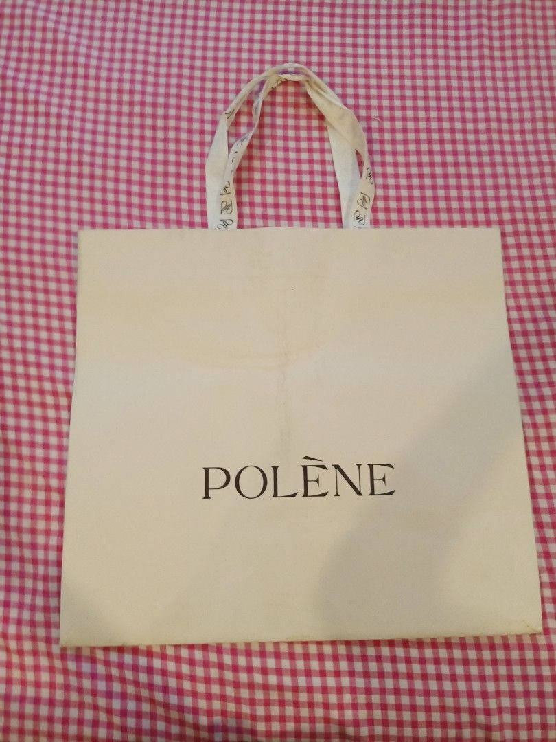 Polène Paper Shopping Bag Gift Bag (Category: Tote Bags) located in Cainta. Submitted by belli_phats (Listing ID 1468090891, Image 1). Description: - Authentic Polène paper shopping bag - Elegant cream exterior with black brand logo - Stylish fabric handles with repeating logo monogram pattern - Sturdy paper construction with a folded bottom gusset - Perfect for gifting, organizing, or collection storage.