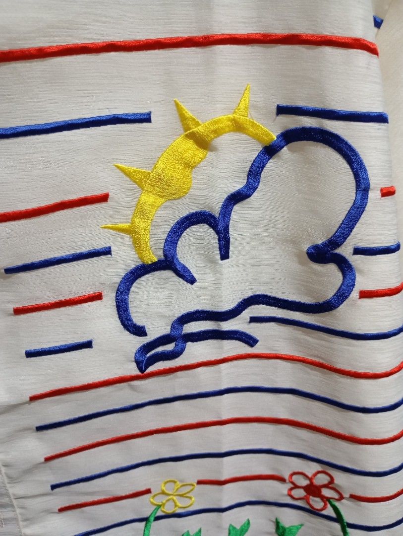 Polo Barong (Category: Looking For) located in Mandaluyong City. Submitted by maruyahachi (Listing ID 1468170126, Image 3). Description: White button-up top with playful embroidered details. Features colorful stripes, sunshine and cloud motifs, plus a charming stick figure illustration on the front. Measures around 21 to 22 inches across the chest and extends past 30 inches in length. Lightweight fabric, front button closure..