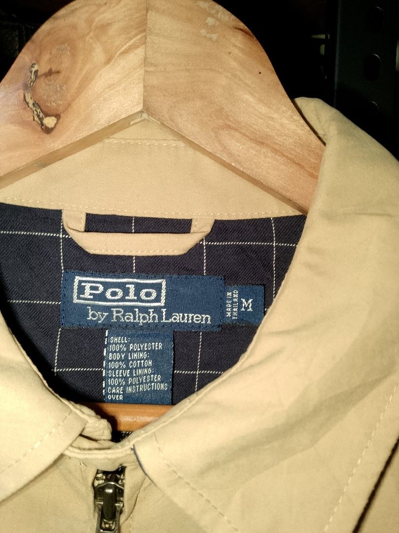 Polo Ralph Lauren Tan Zip-Up Jacket Size M (Category: Coats, Jackets and Outerwear) located in Manila. Submitted by mjthrifted_second (Listing ID 1468086749, Image 2). Description: - Brand: Polo Ralph Lauren - Style: Tan zip-up jacket - Size: M (Made in Thailand) -Dimes: 24/26 - Materials: 100% polyester shell, 100% cotton body lining, 100% polyester sleeve lining - Details: Classic blue embroidered pony logo on chest, stylish navy plaid inner li