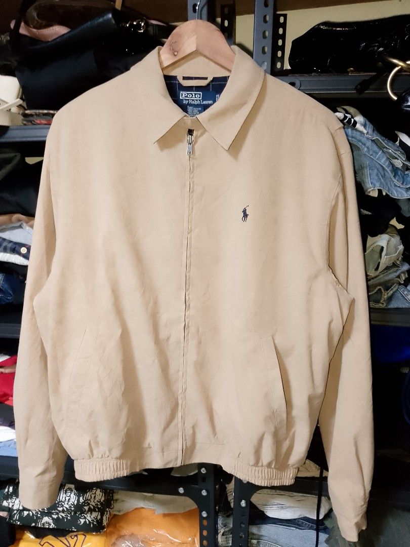 Polo Ralph Lauren Tan Zip-Up Jacket Size M (Category: Coats, Jackets and Outerwear) located in Manila. Submitted by mjthrifted_second (Listing ID 1468086749, Image 1). Description: - Brand: Polo Ralph Lauren - Style: Tan zip-up jacket - Size: M (Made in Thailand) -Dimes: 24/26 - Materials: 100% polyester shell, 100% cotton body lining, 100% polyester sleeve lining - Details: Classic blue embroidered pony logo on chest, stylish navy plaid inner li