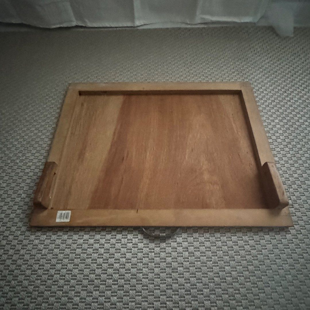 Portable Art Table with handle (Category: Craft Supplies & Tools) located in Marikina City. Submitted by repurpose_studio (Listing ID 1468110710, Image 2). Description: - 20x30cm - Features raised wooden framing on three sides and supporting blocks on the inside base - Attached metal handle at the top for convenient hanging or carrying - Shows minor scuffs, scratches, a vertical front mark, and slight corner wear from normal use - Durable and stu